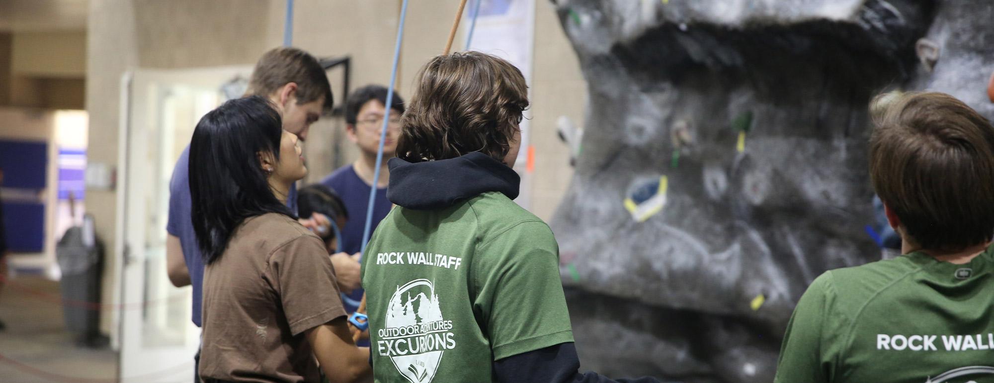 Students at the rock wall practice climbing and tying knots