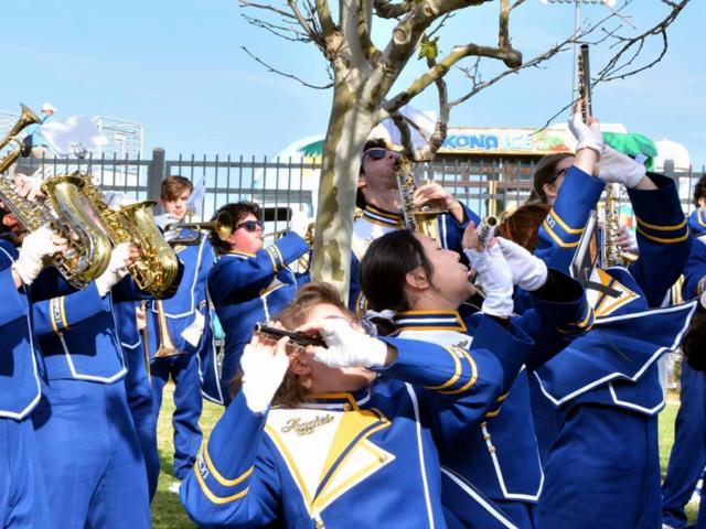 Marching band members playing outside