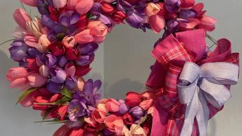 Floral wreath with purple and pink flowers and bows