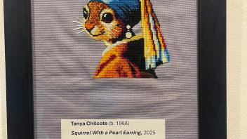 cross stitch of squirrel with a pearl earring
