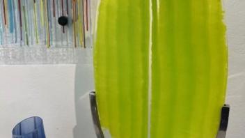 oval shaped spring green and clear fused glass in metal stand