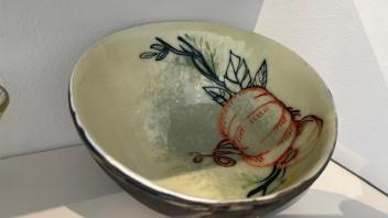 fused glass bowl with a painted pumpkin inside