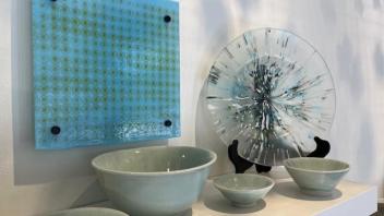 arrangement of blue fused glass and ceramic bowls