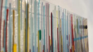 detail view of fused glass panel with streaky rainbow colors on clear