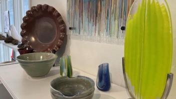 arrangement of fused glass and ceramics on a shelf