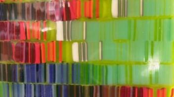 Glass detail evoking DNA sequencing on a green background