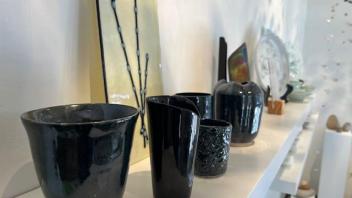 arrangement of black ceramic cups with a fused glass willow panel 