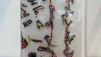 fused glass panel, white with dribbled multicolor trails in a wood block