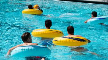 student in tubes in pool