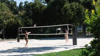 students playning on sand volleyball court