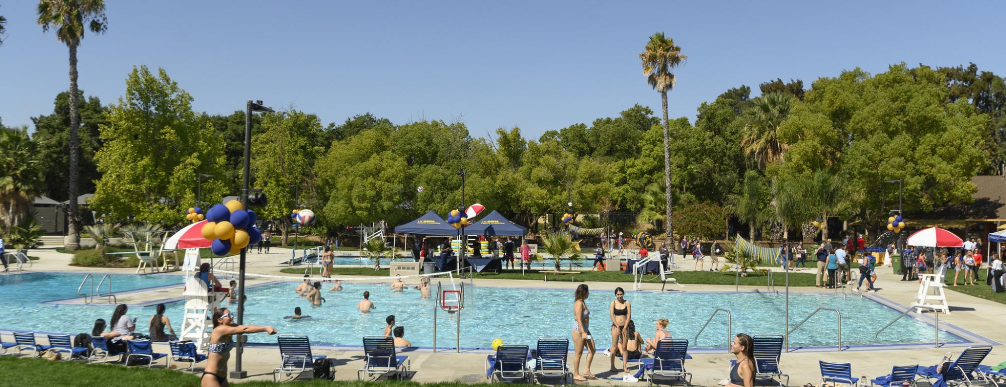 Two students passing volleyball at the UCD rec pool.jpg
