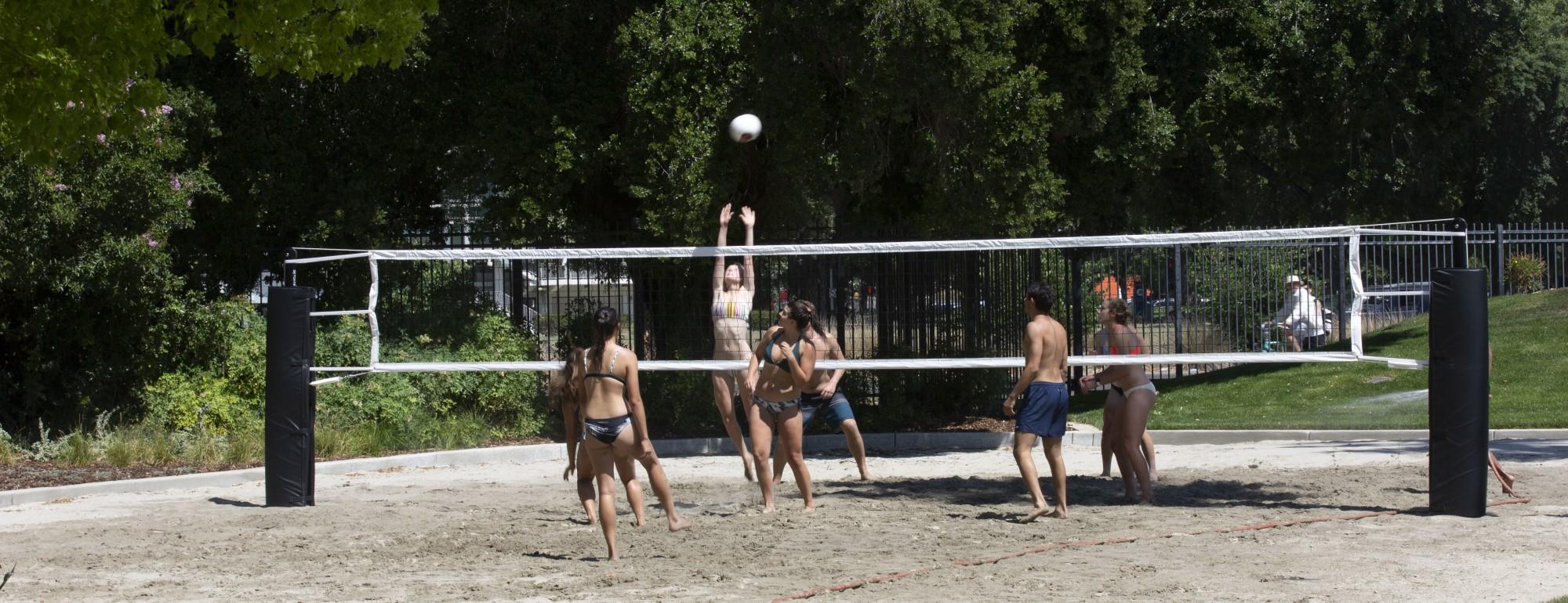 Students playing beach volleyball at the Rec Pool