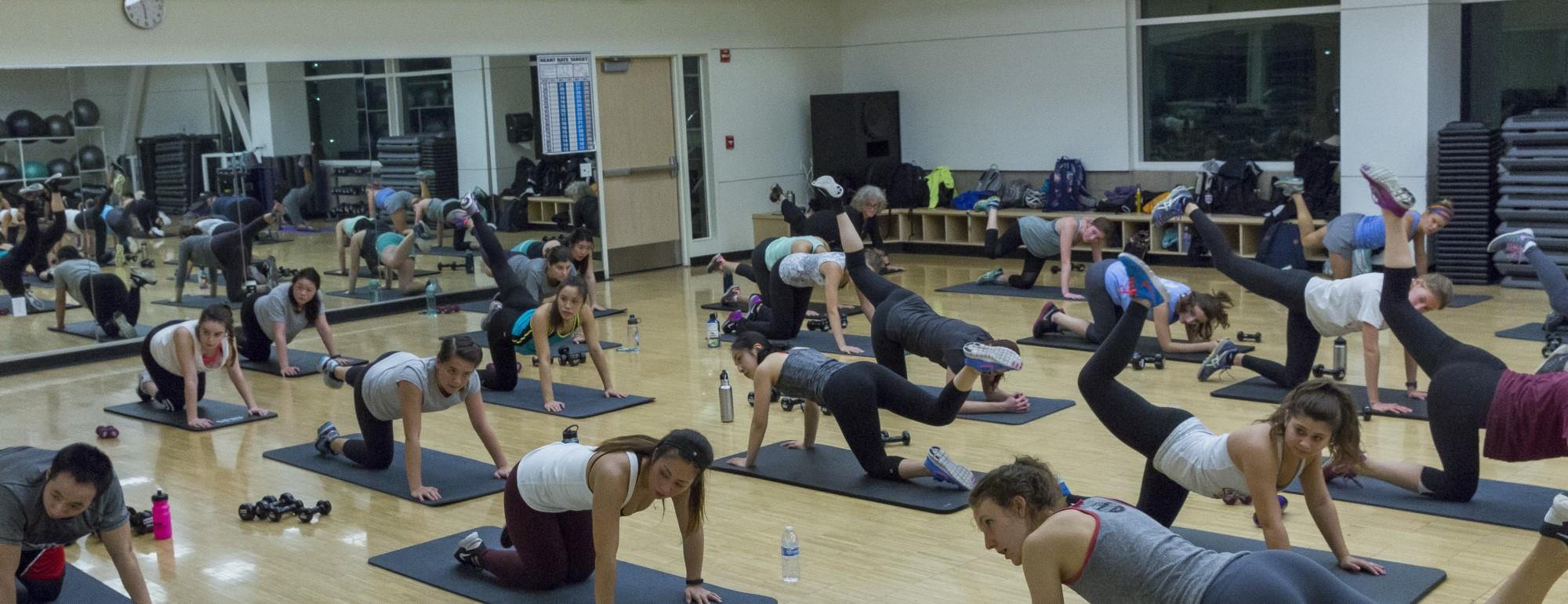 Students participating in a group exercise class in a studio at the ARC