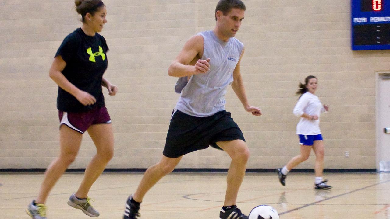 Photo of Chris playing indoor soccer