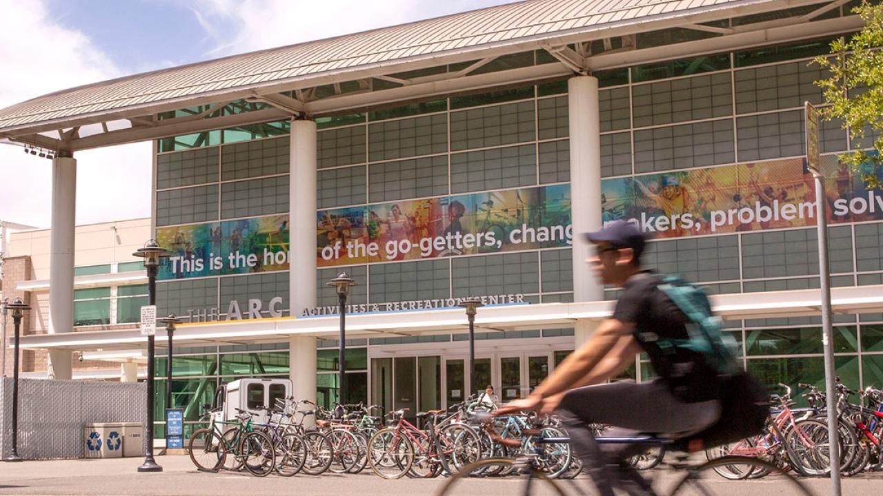 person riding bike in front of the ARC facility