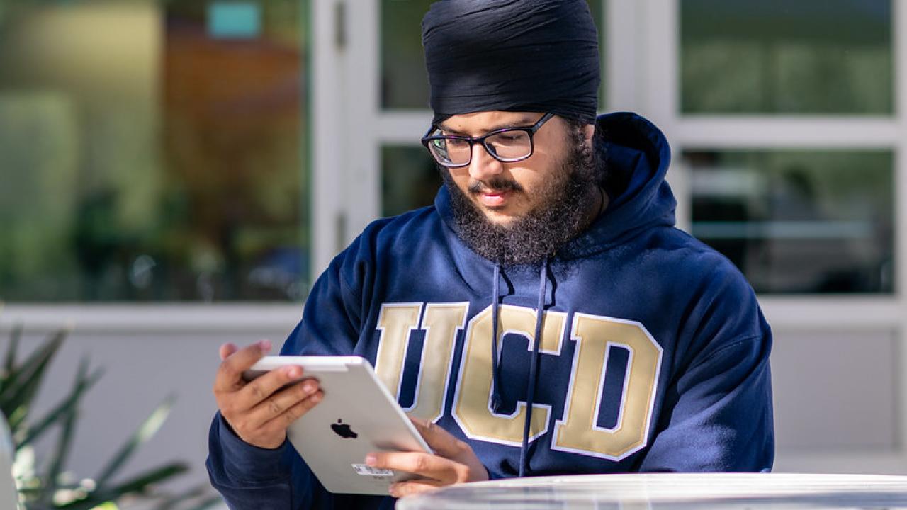 A student looking at their iPad. 