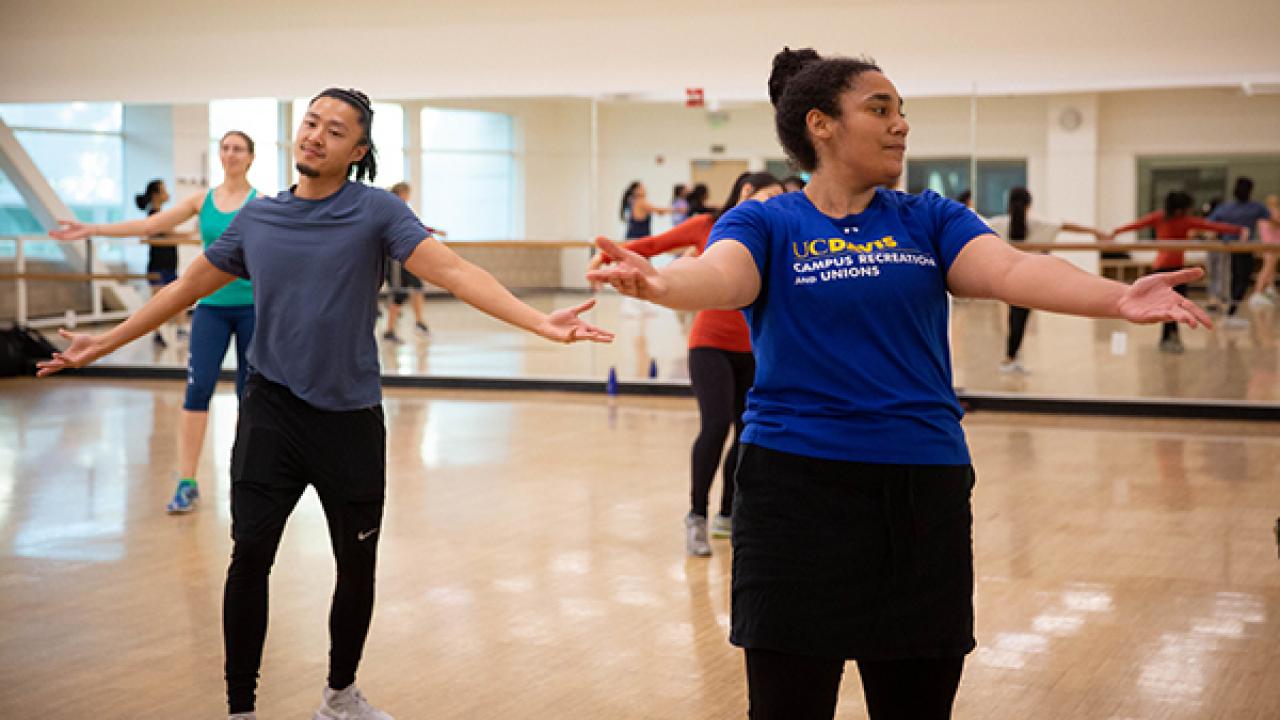 People exercise in an indoor group class