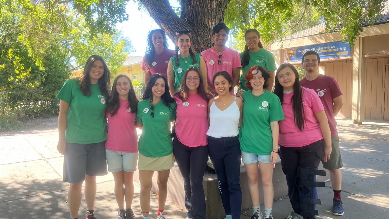 Youth Programs leadership team poses for a group photo in front of a tree.