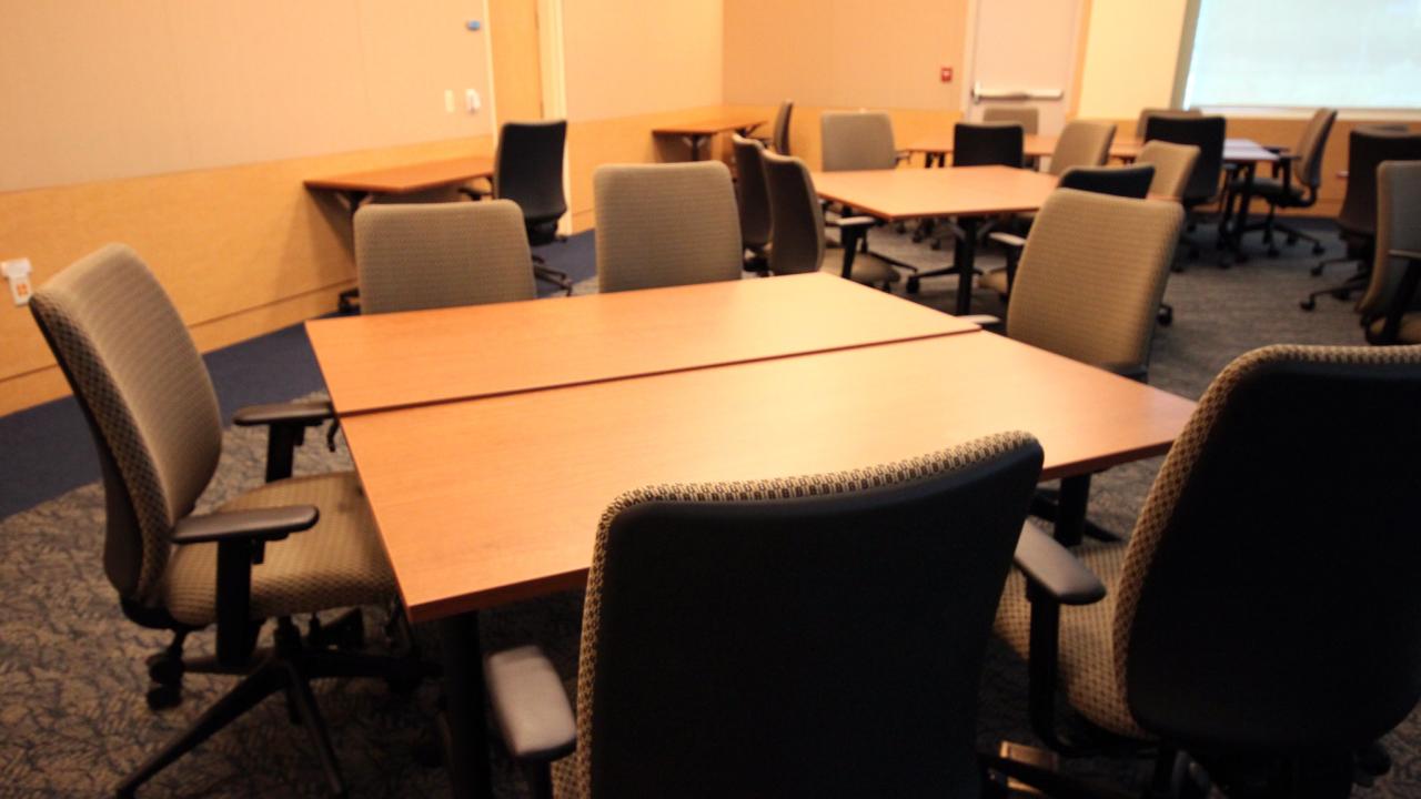 Picture of empty meeting room with a Table and Chairs