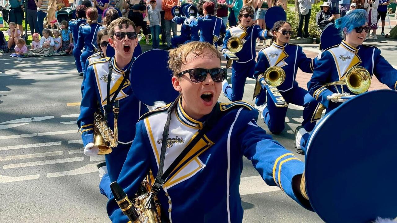 Marching band members playing outside