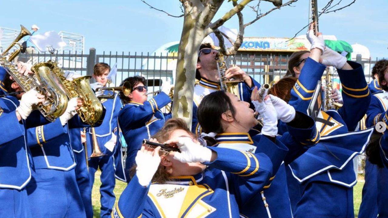 Marching band members playing outside