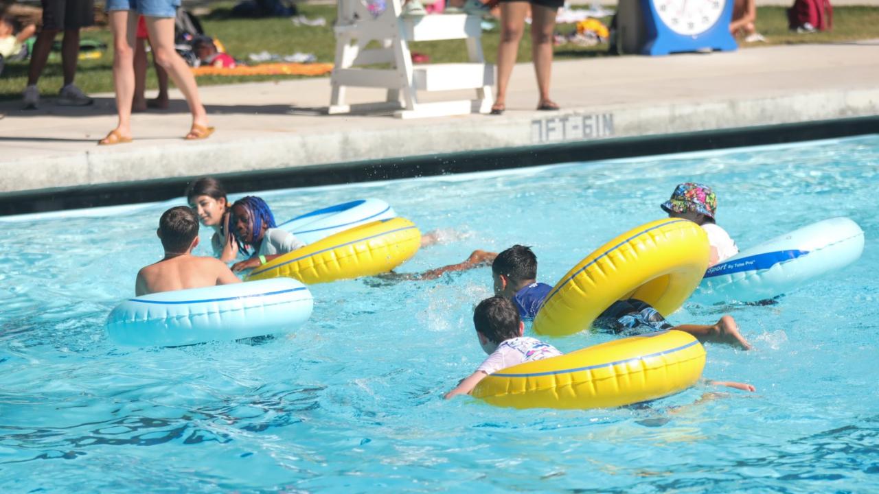 campers playing splashball at the Rec Pool while counselors relay advice.