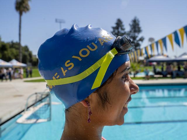Woman in swim cap and goggles