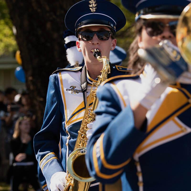 A marching band member walking through the Picnic Day Parade