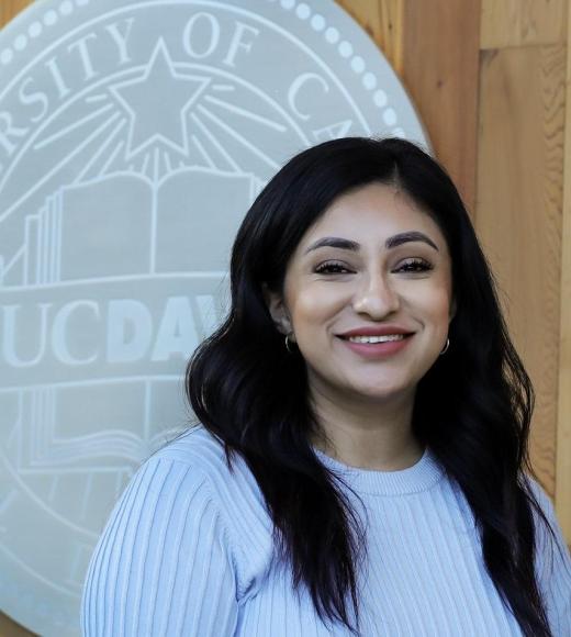 Headshot of Franny in front of the UC Davis seal