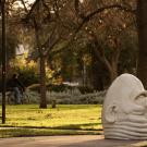 The "eye on Mrak" egghead sits in the righthand side of the frame. Two bikers cycle passed in the background.