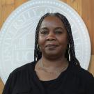 Headshot of Andrea in front of the UC Davis seal