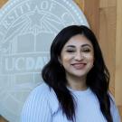Headshot of Franny in front of the UC Davis seal