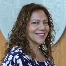 Headshot of Rosanna in front of the UC Davis seal