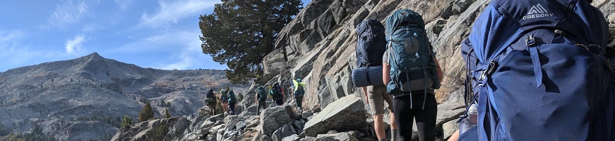 group backpacking on side on mountain