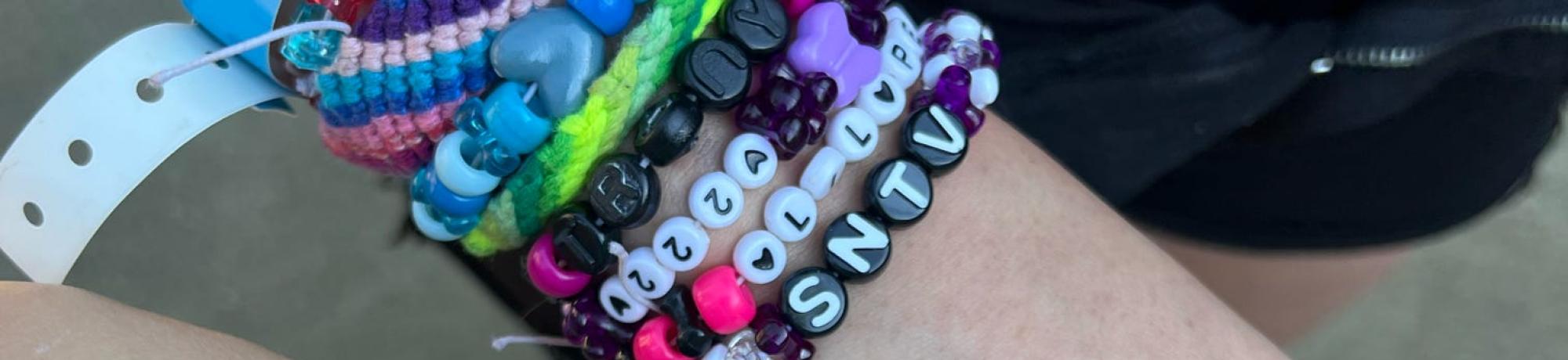 arms together showing each others colorful bracelets