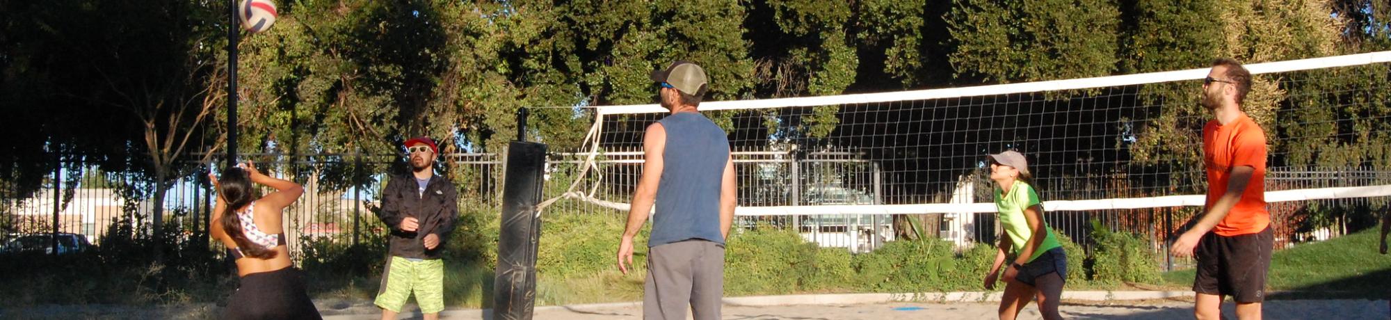 Players playing Beach Volleyball at Rec Pool beach courts.